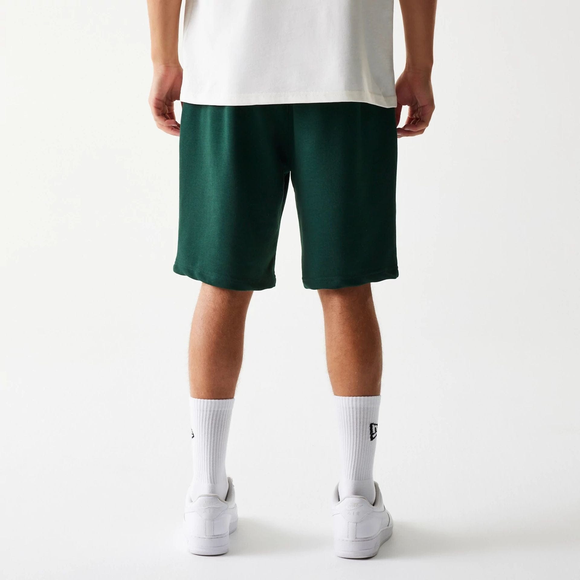 The Male model is wearing New Era Front Logo Dark Green Shorts 2