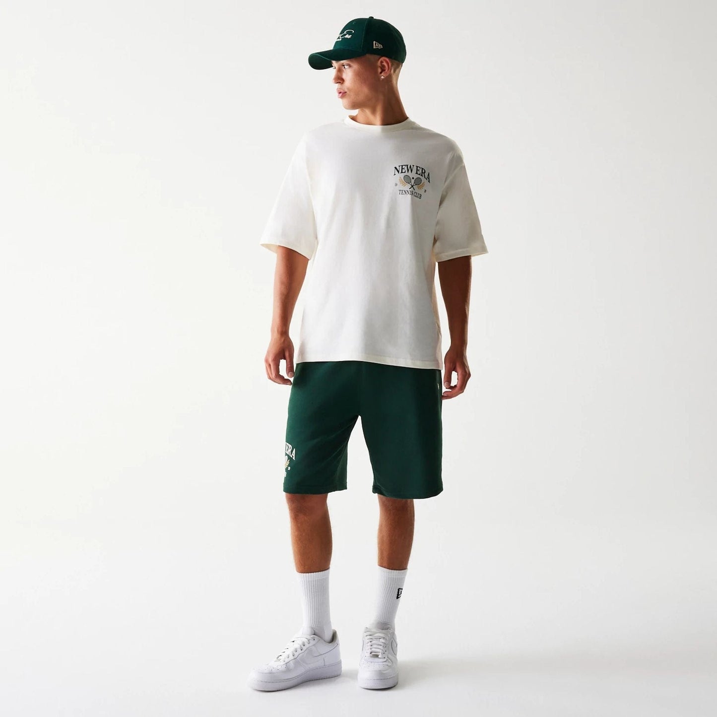 The Male model is wearing New Era Front Logo Dark Green Shorts 8