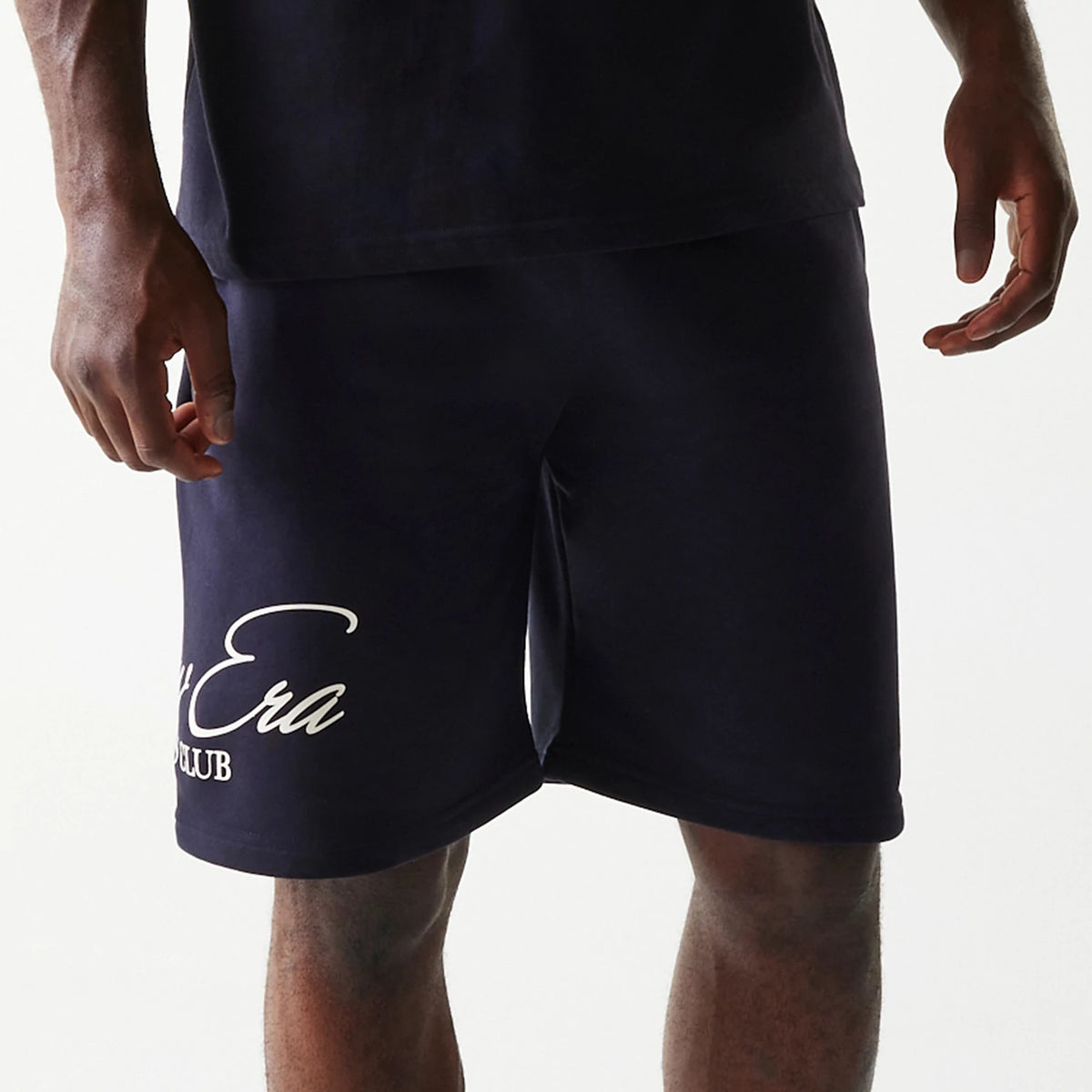 The Male model is wearing New Era Side Logo Navy Shorts 3