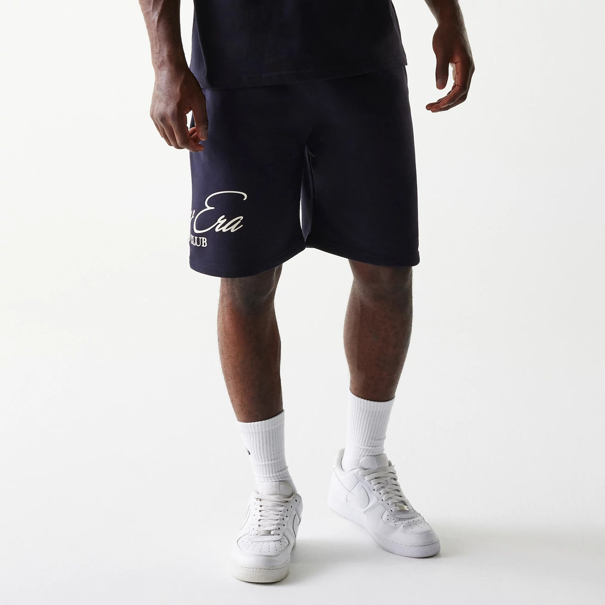 The Male model is wearing New Era Side Logo Navy Shorts 1