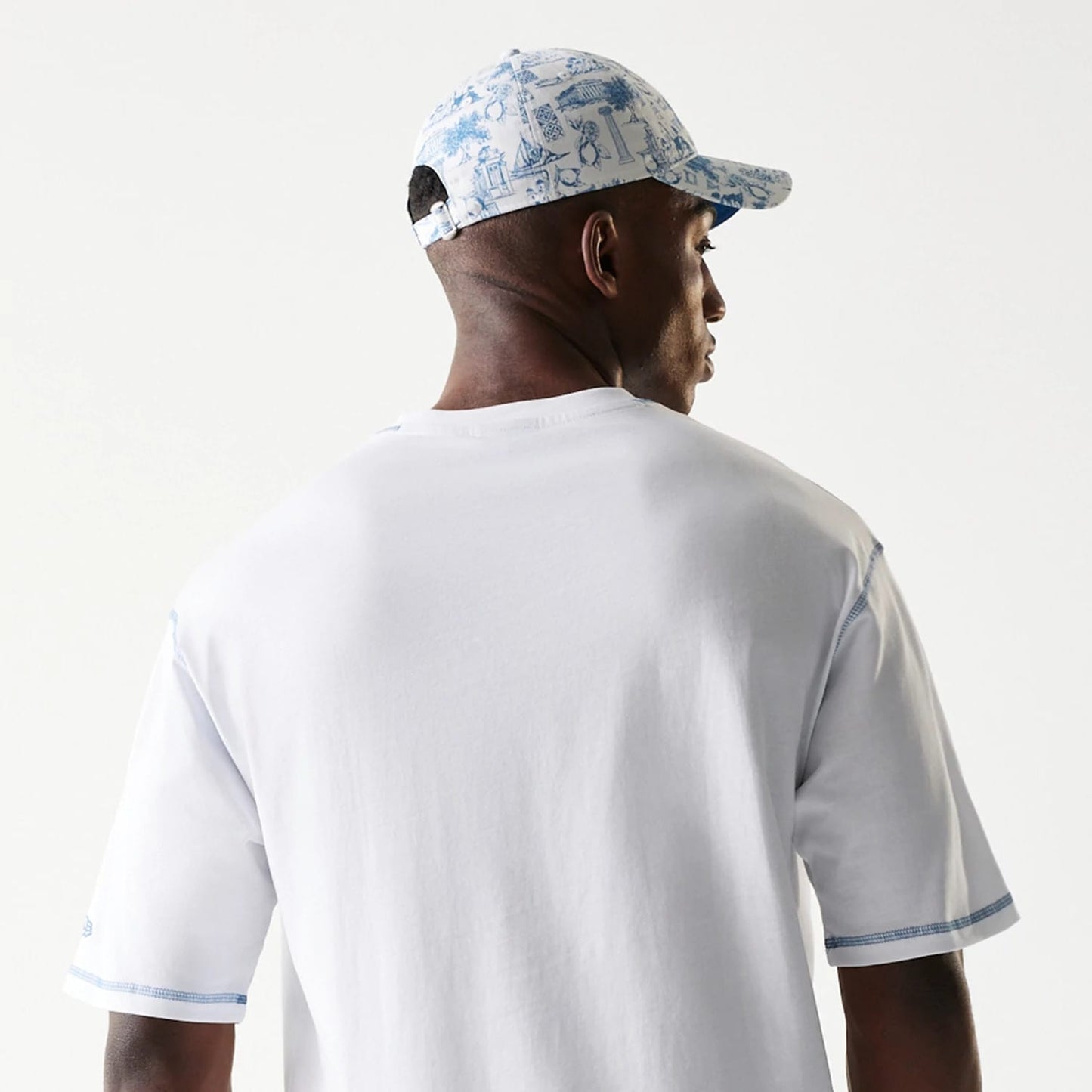 The Male model is wearing New Era Orthodox Vase White Oversized T-Shirt 7
