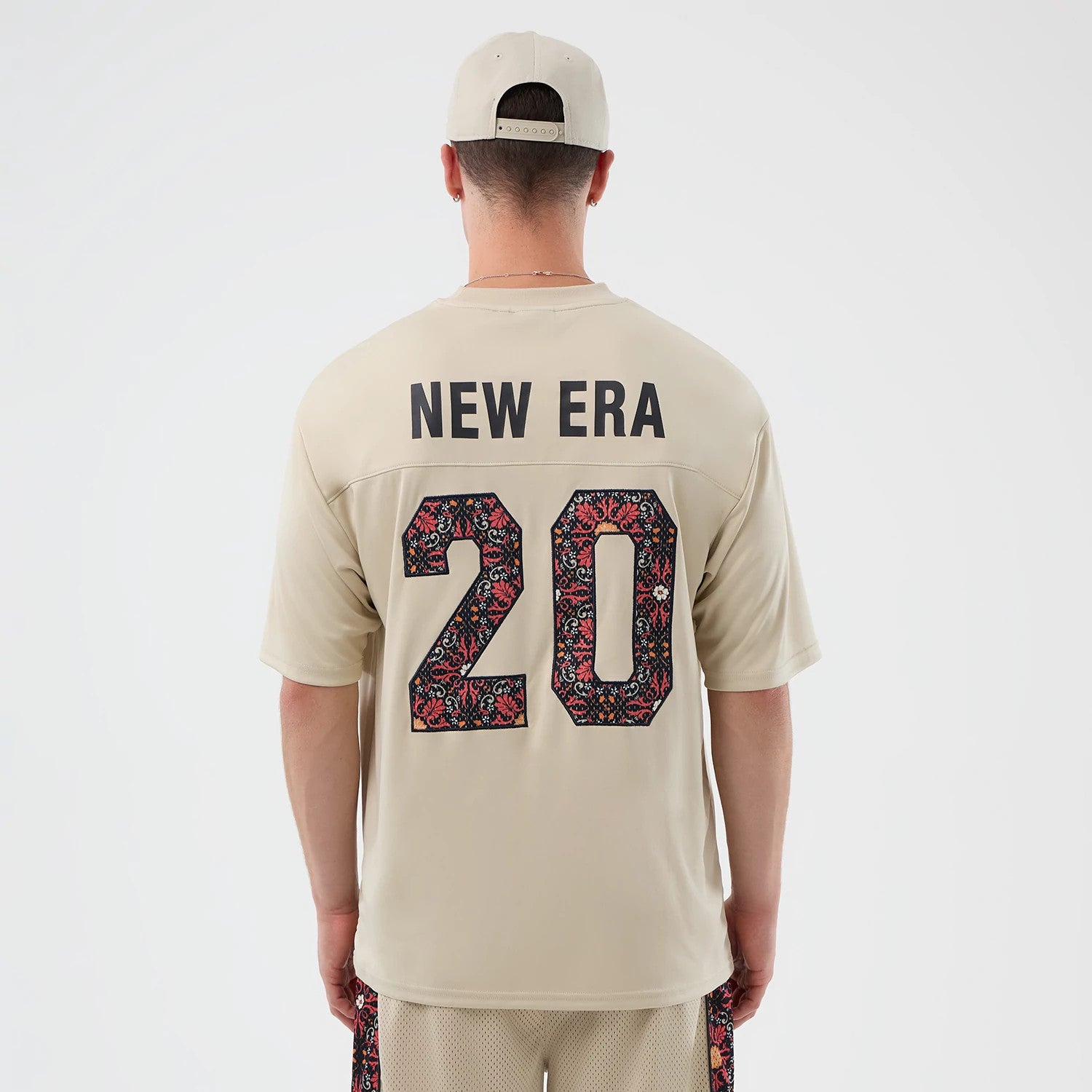The Male model is wearing New Era Mesh Infill Light Beige Oversized T-Shirt 2
