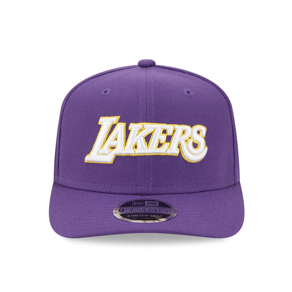 LA Lakers NBA Statement Purple New Era 9SEVENTY Stretch Snap Adjustable Cap, front view showing the raised Lakers logo in white and gold embroidery on the centre of the front panel, with a matching purple visor featuring a 9SEVENTY size sticker.