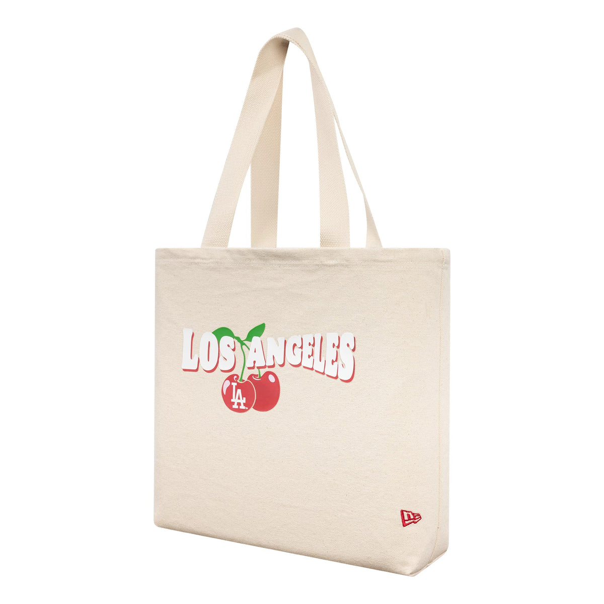 New Era LA Dodgers MLB Fruit Cream Tote Bag, three-quarter view showing cream-coloured tote with large Los Angeles lettering and cherries graphic, embroidered New Era logo in red at the bottom corner, and shoulder straps.