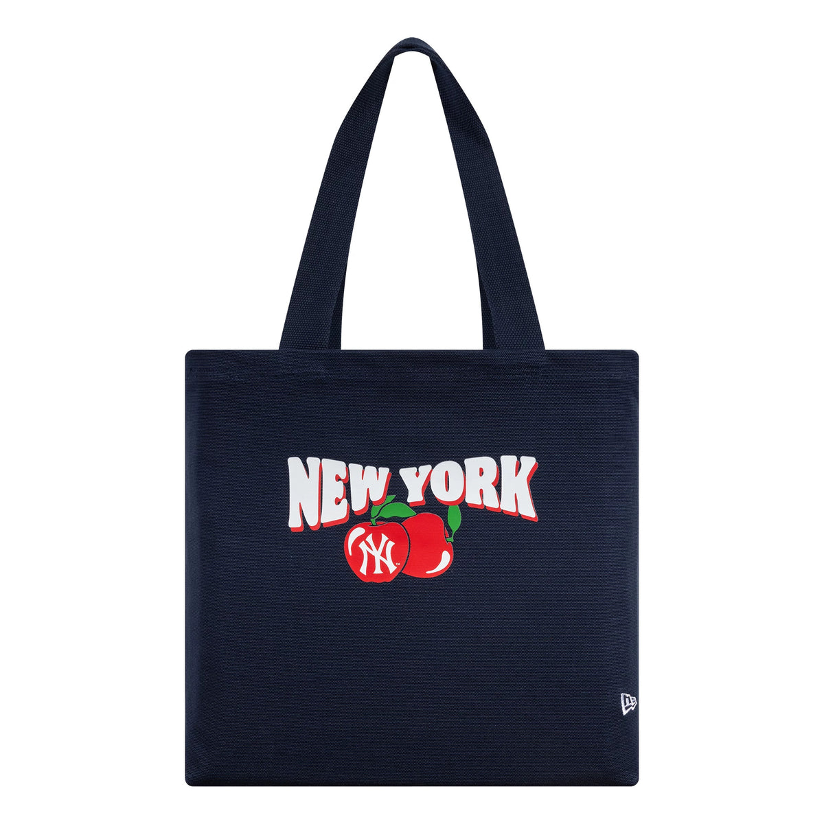 New Era New York Yankees MLB Fruit Navy Tote Bag, front view showing a New York graphic with two red apples including a white NY logo, and a small embroidered New Era flag logo at the bottom corner of the bag.