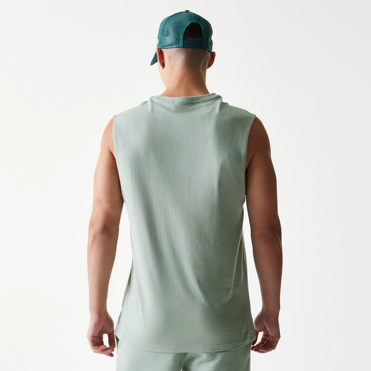 The model is wearing this MLB League Essential LA Dodgers Sleeveless T-Shirt in pastel green. 2