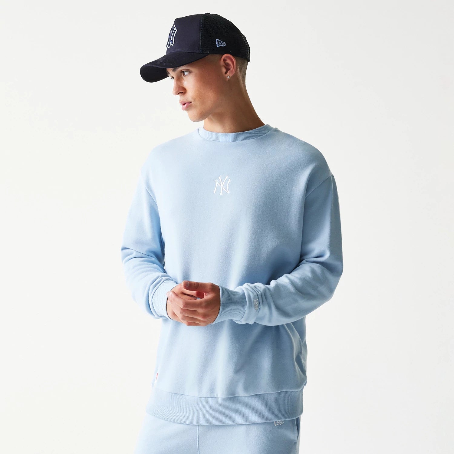 The model is wearing this MLB League Essential Midi New York Yankees Oversized Crew Neck Sweater in blue. 1