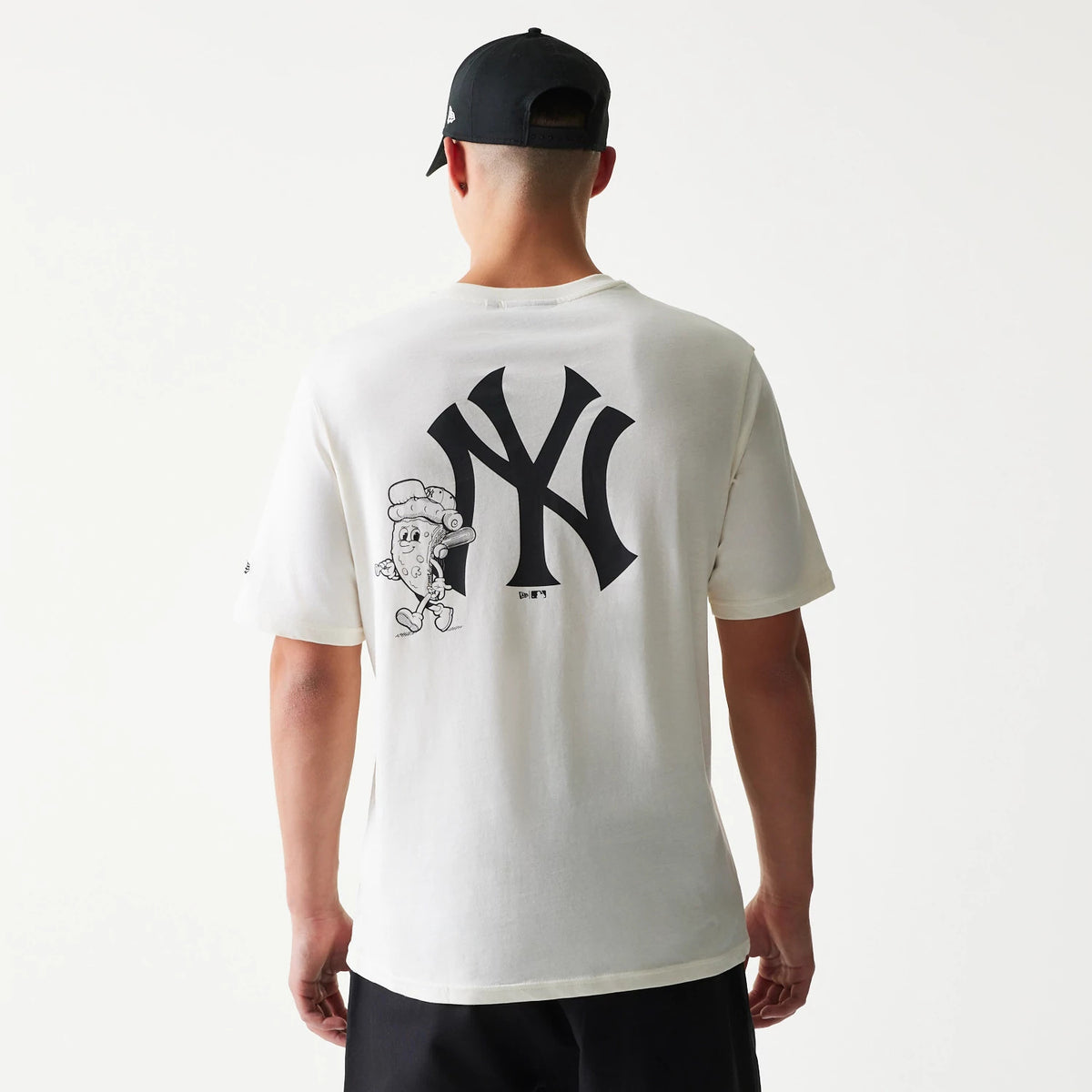 New Era New York Yankees MLB Food Graphic Open White T-Shirt, back view on a model showing a large black NY Yankees logo centred with a playful cartoon food graphic on the left side of the back.