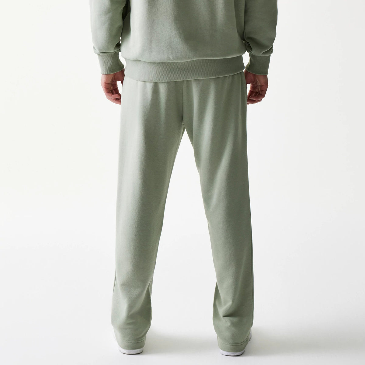 New Era LA Lakers NBA Pastel Green Straight Leg Joggers, back view on a model showing the relaxed fit and elasticated waist, with the soft pastel green fabric extending to the straight-cut cuffs.