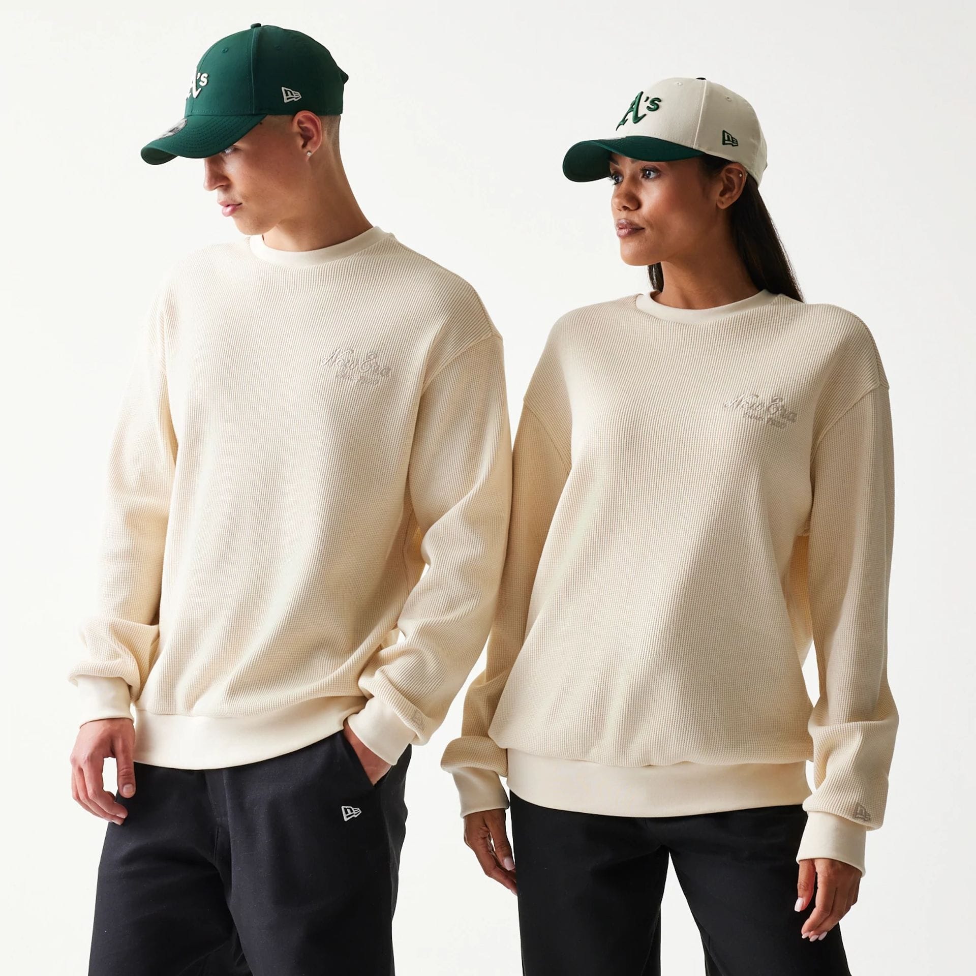 The model is wearing this New Era Script Waffle Crew Neck Sweater in light beige. 1
