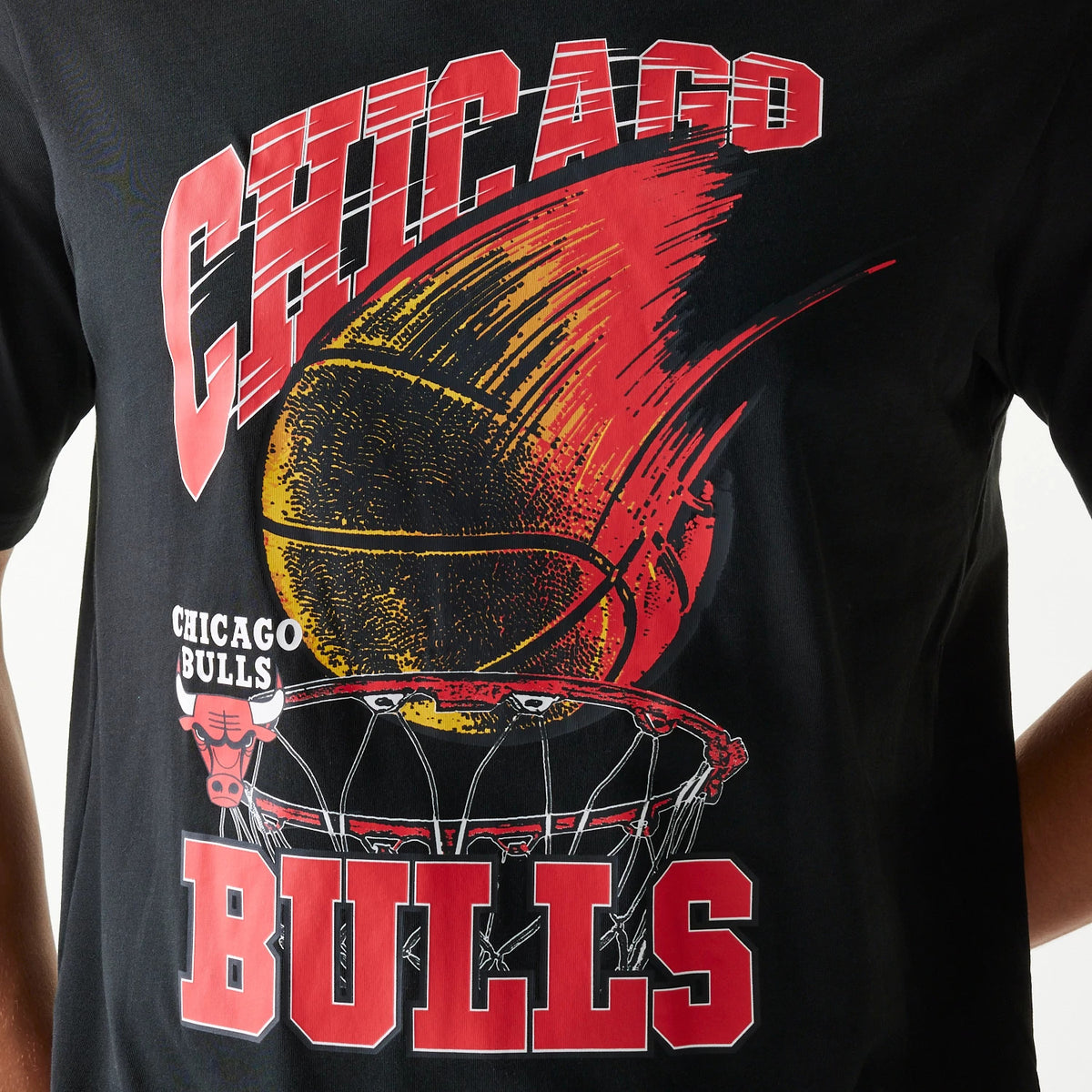 New Era Chicago Bulls NBA Ball Graphic Black T-Shirt, front view showing a print with a large flaming basketball graphic, Chicago Bulls text in red and white, and an illustrated basketball hoop covering the chest area.