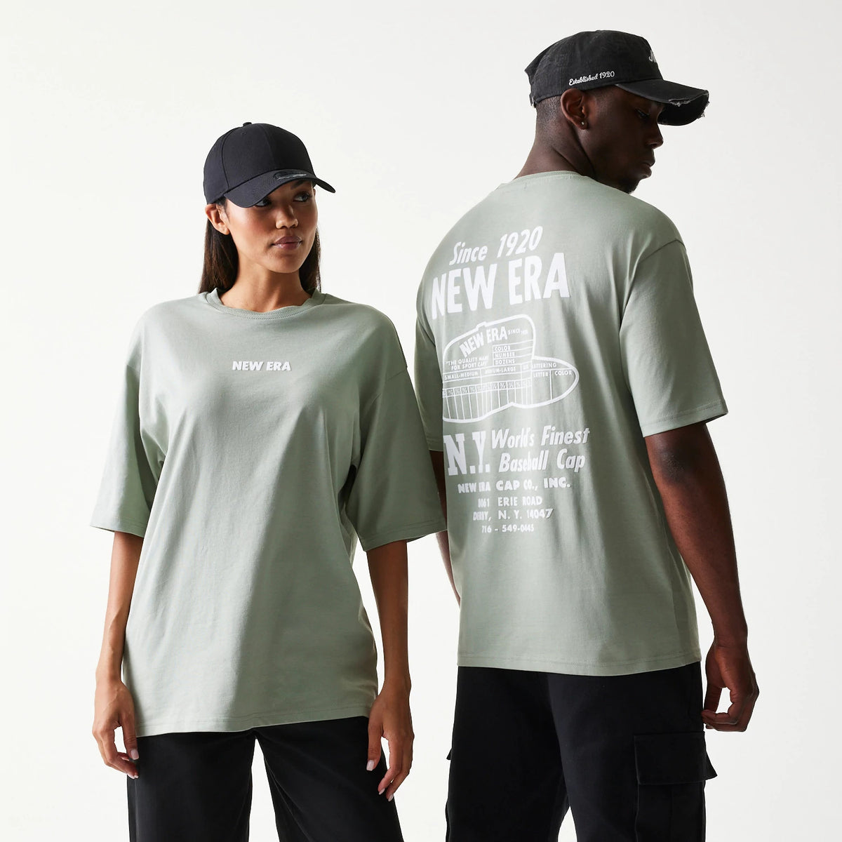 New Era Graphic Pastel Green Oversized T-Shirt, on-model front and back view showing the small front New Era print and large back graphics with Since 1920 lettering in white, styled with black caps.