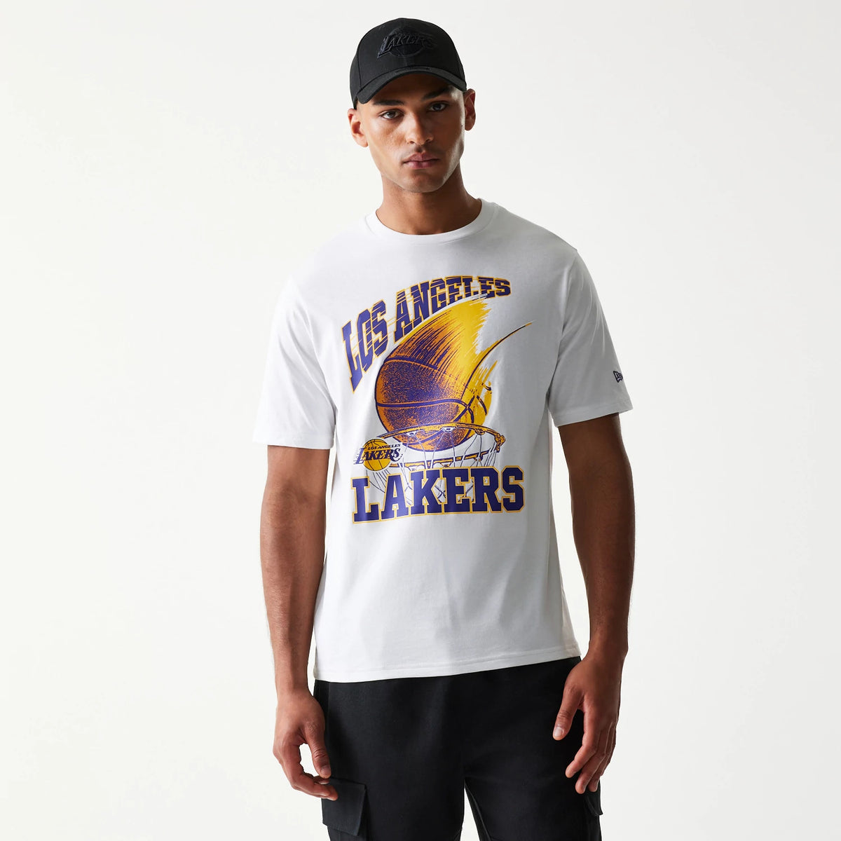New Era LA Lakers NBA Ball Graphic White T-Shirt, front view on-model featuring Los Angeles Lakers text above a dynamic gold and purple basketball graphic, with a small embroidered New Era logo on the sleeve.