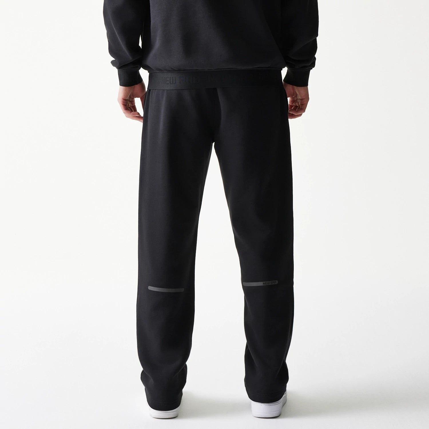 The model is wearing this New Era Tech Straight Leg Joggers in black on black. 2
