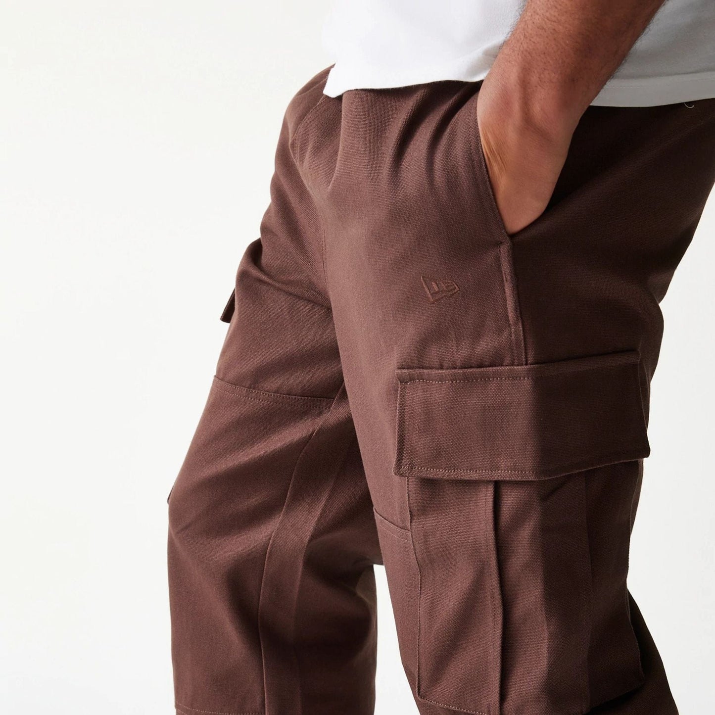 The model is wearing this New Era Straight Leg Cargo Joggers in brown. 8