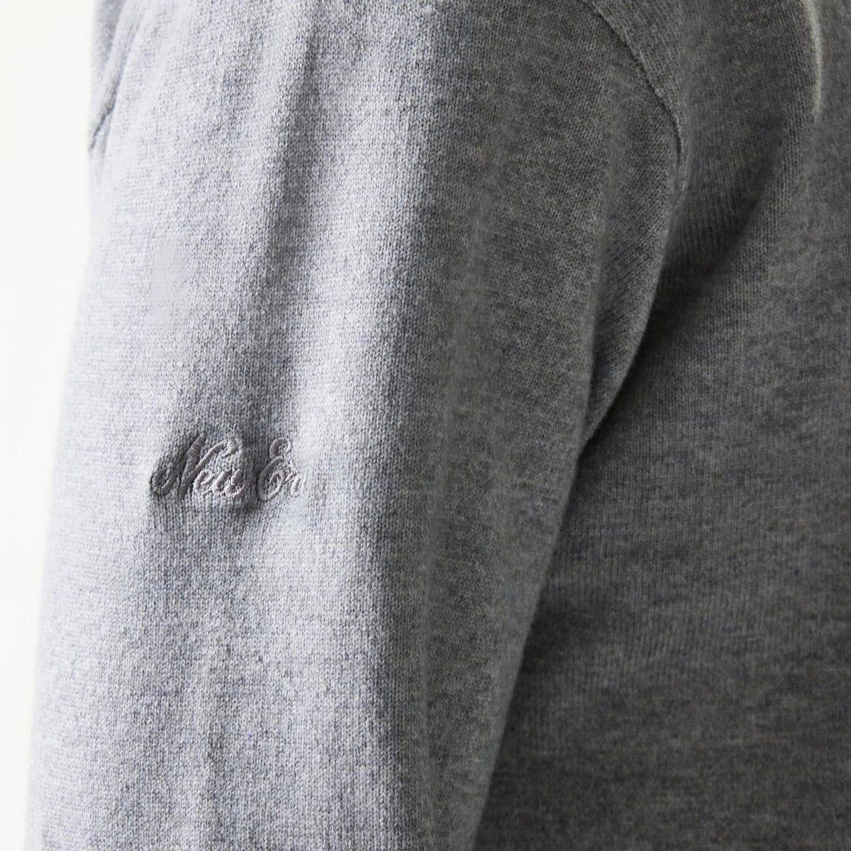 The model is wearing this New Era Essential Flag Knitted Sweater in grey. 8