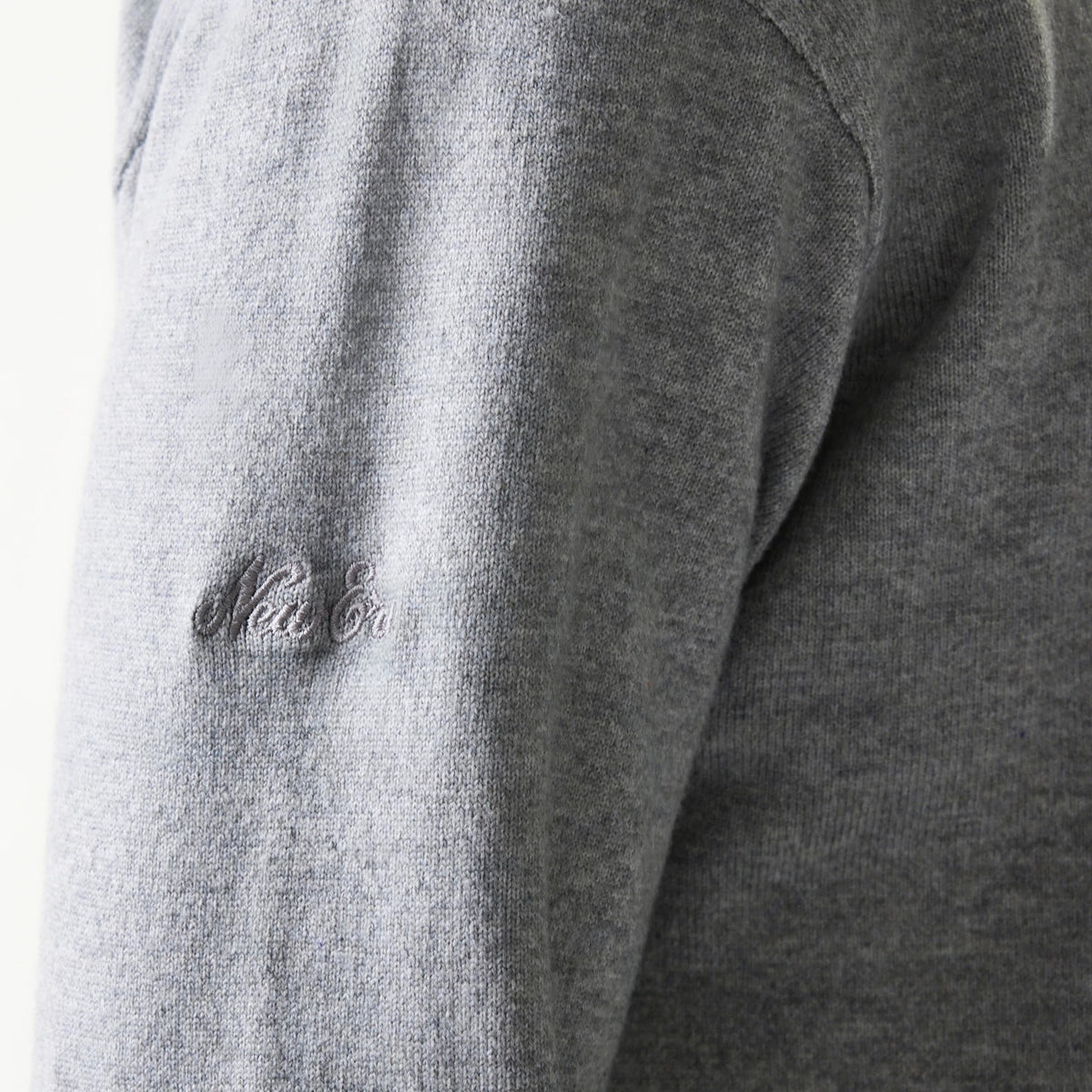 The model is wearing this New Era Essential Flag Knitted Sweater in grey. 8