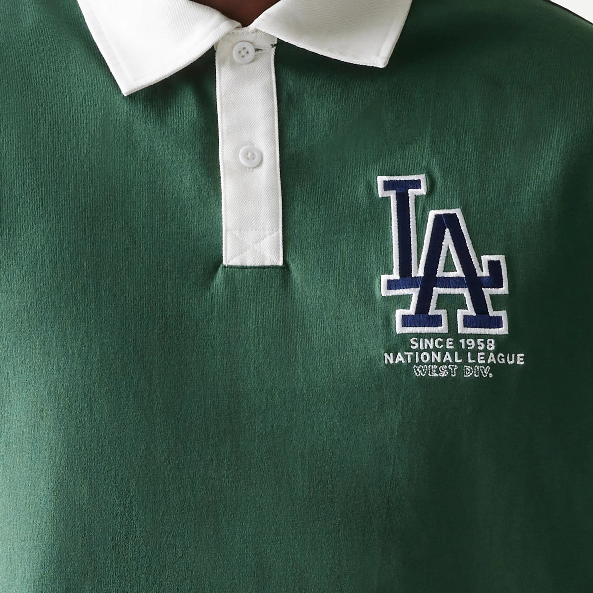 New Era LA Dodgers MLB Dark Green Oversized Polo T-Shirt, front view showing a white embroidered LA logo and the text Since 1958 National League West Div on a deep green background beneath a white button-up collar.