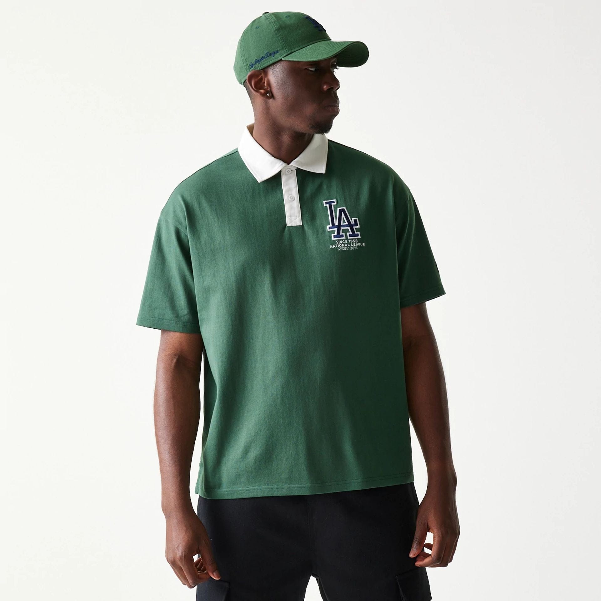The model is wearing this MLB LA Dodgers Oversized Polo T-Shirt in dark green. 1