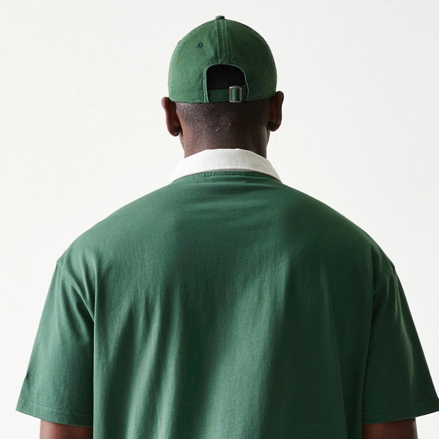 The model is wearing this MLB LA Dodgers Oversized Polo T-Shirt in dark green. 7