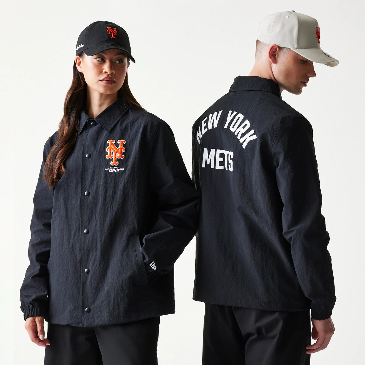 New Era New York Mets MLB Coaches Black Jacket, front and back view on models showing the orange embroidered NY Mets logo on the chest of the button-up front and New York Mets lettering across the upper back in white.