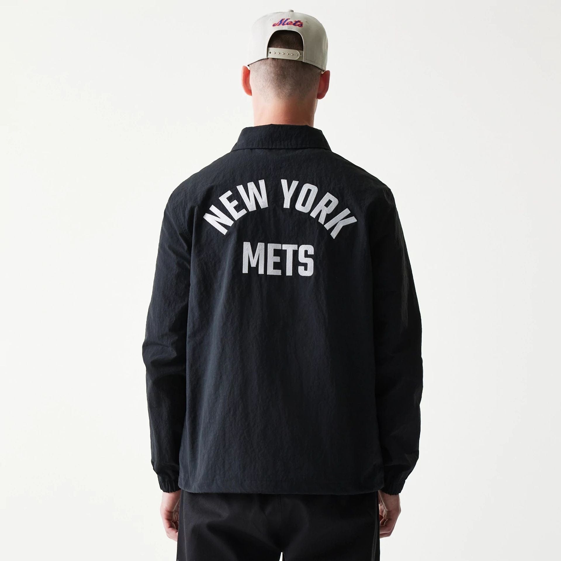 The model is wearing this MLB Coaches New York Mets Jacket in black. 2