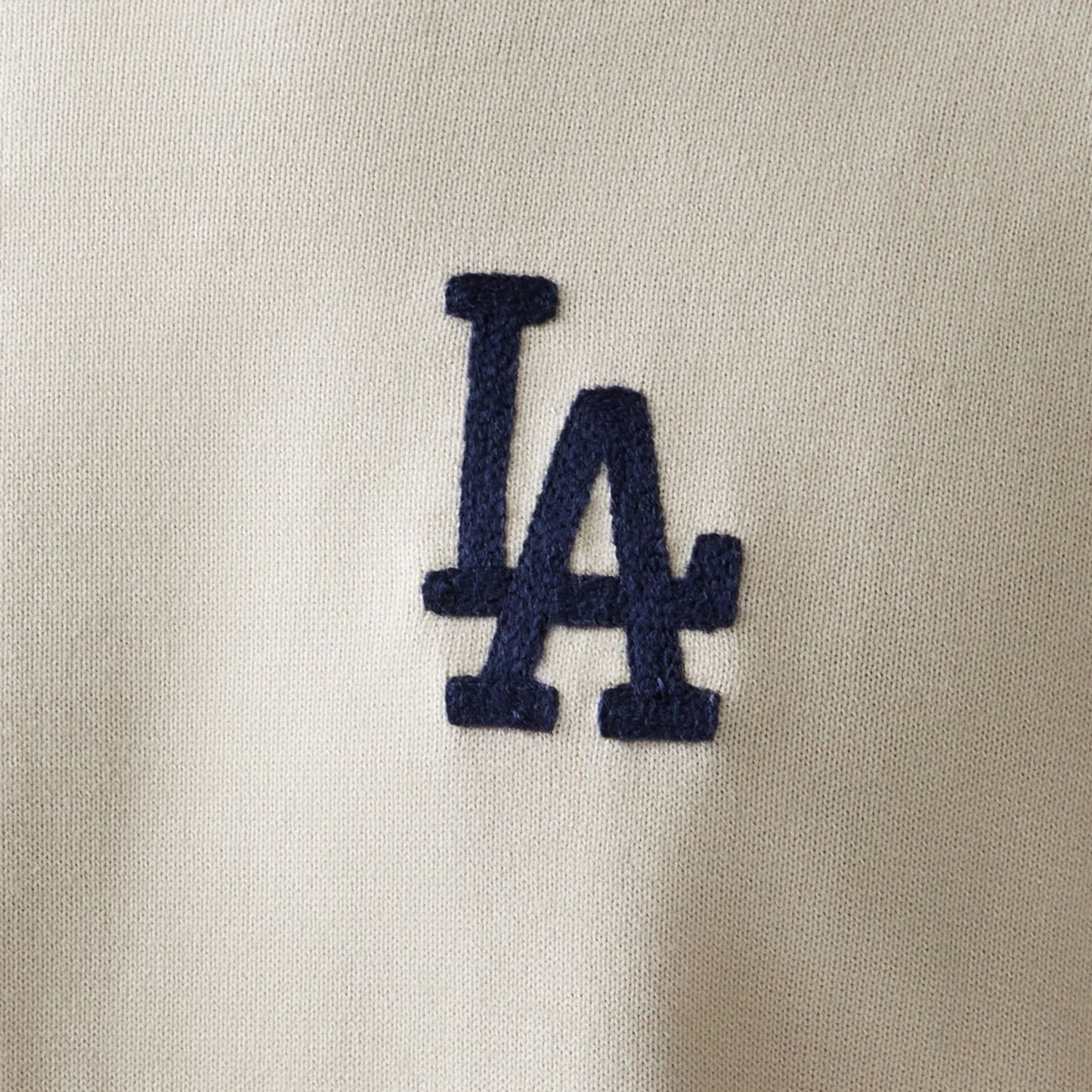 The model is wearing this MLB Essential LA Dodgers Knitted Sweater in open white. 8