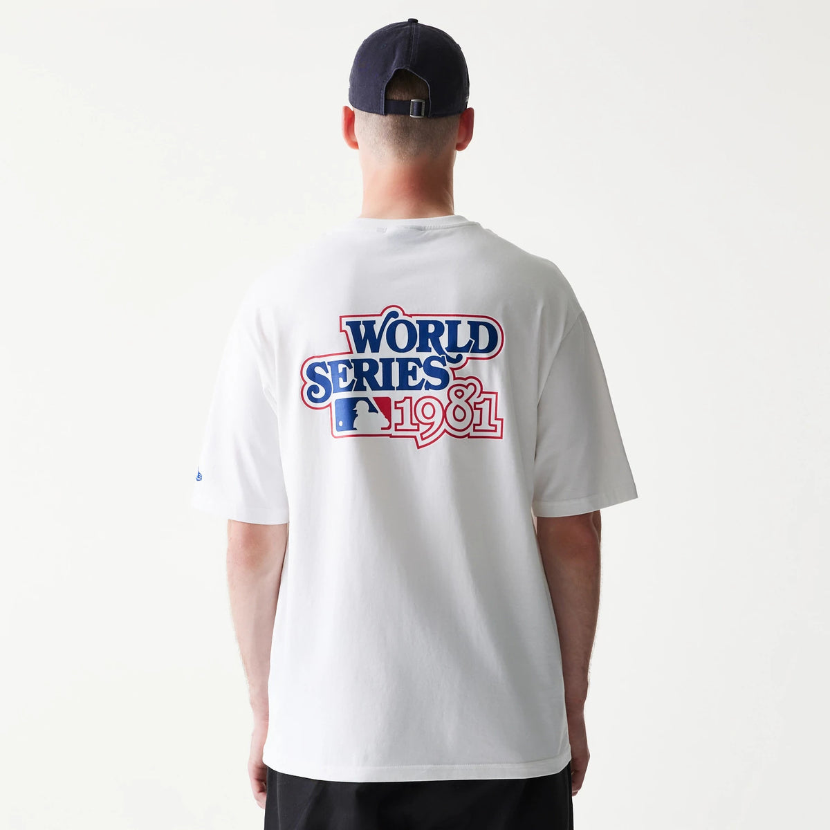 New Era LA Dodgers MLB World Series White T-Shirt, back view showing the large World Series 1981 graphic in blue, red, and white, centred on the upper back, worn by a model with a dark cap.