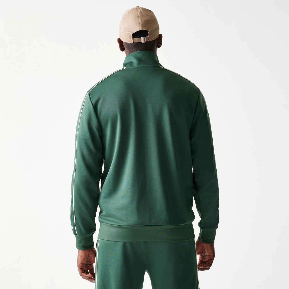 New Era LA Dodgers MLB Piping Dark Green Track Jacket, back view on-model featuring a clean dark green finish, contrasted by white piping along the shoulders and sleeves, paired with matching track pants.