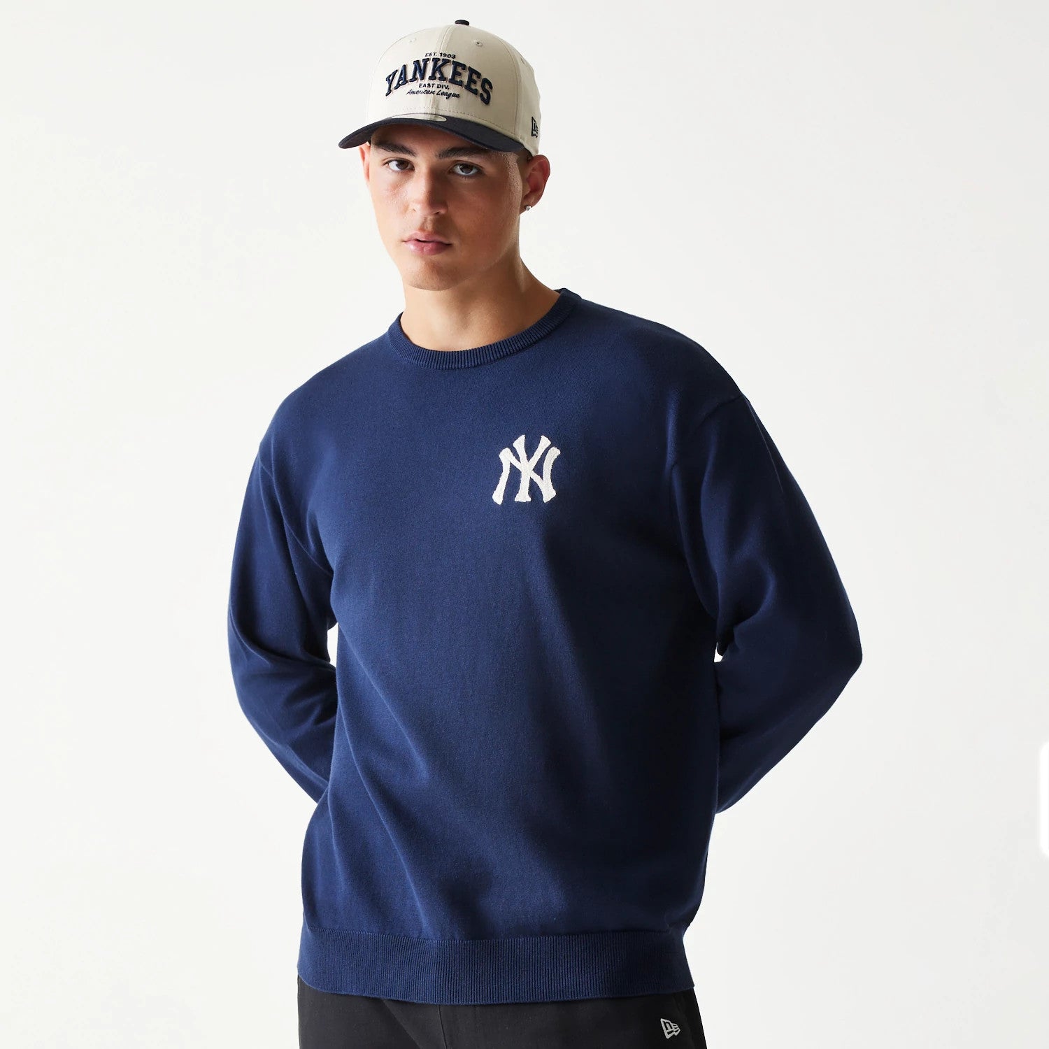 The model is wearing this MLB Essential New York Yankees Knitted Sweater in navy. 3