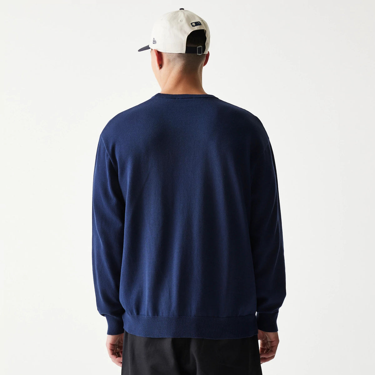 New Era New York Yankees MLB Essential Navy Knitted Sweater, back view on-model showing the seamless navy knit fabric with long sleeves and ribbed cuffs, creating a clean silhouette with a fitted hem.