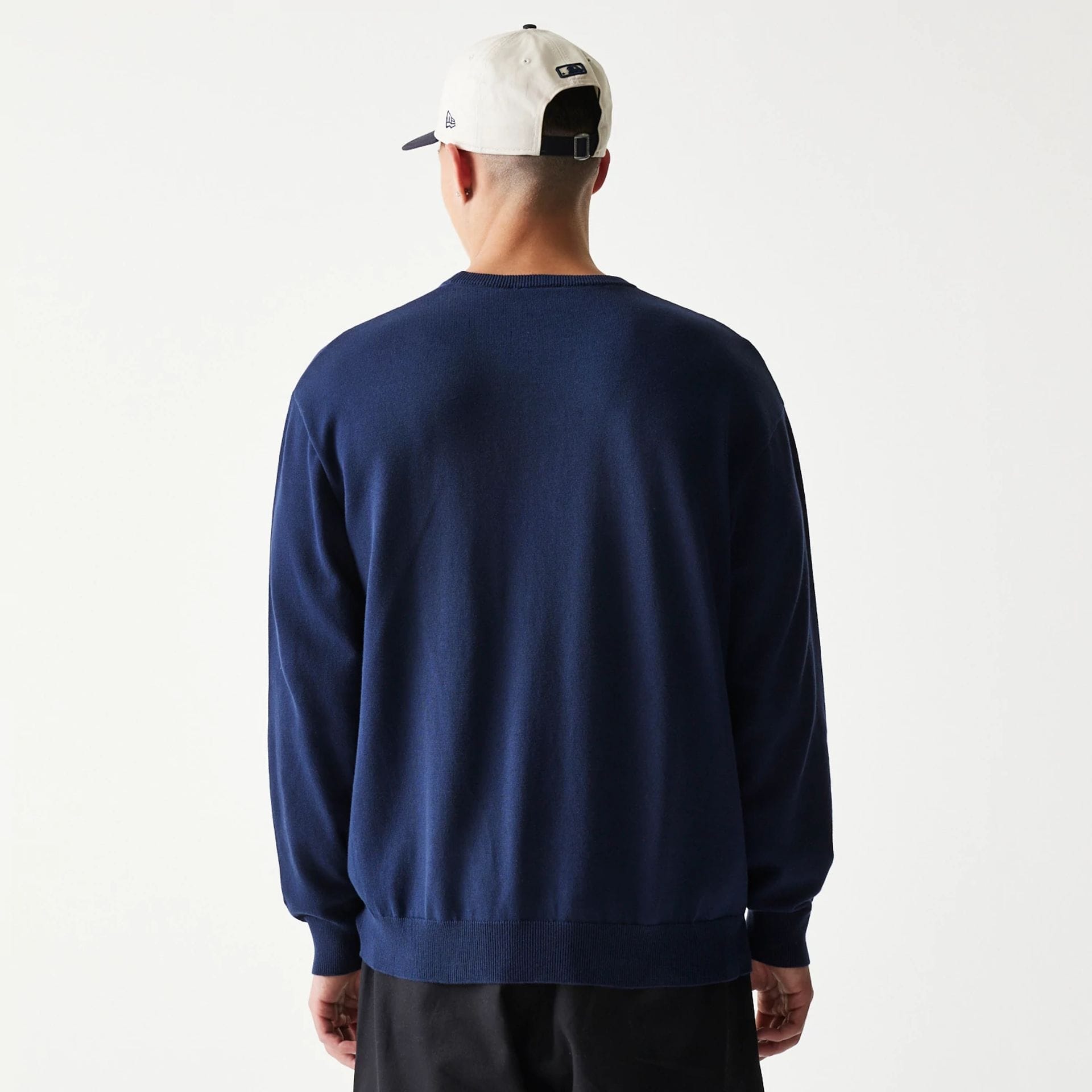 The model is wearing this MLB Essential New York Yankees Knitted Sweater in navy. 2