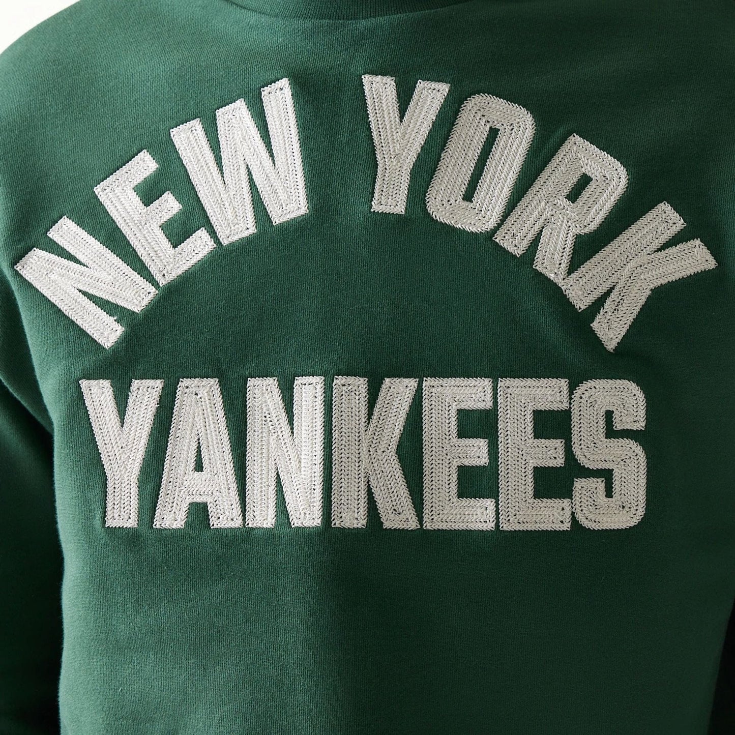 The model is wearing this MLB Graphic New York Yankees Oversized Crew Neck Sweater in dark green. 8