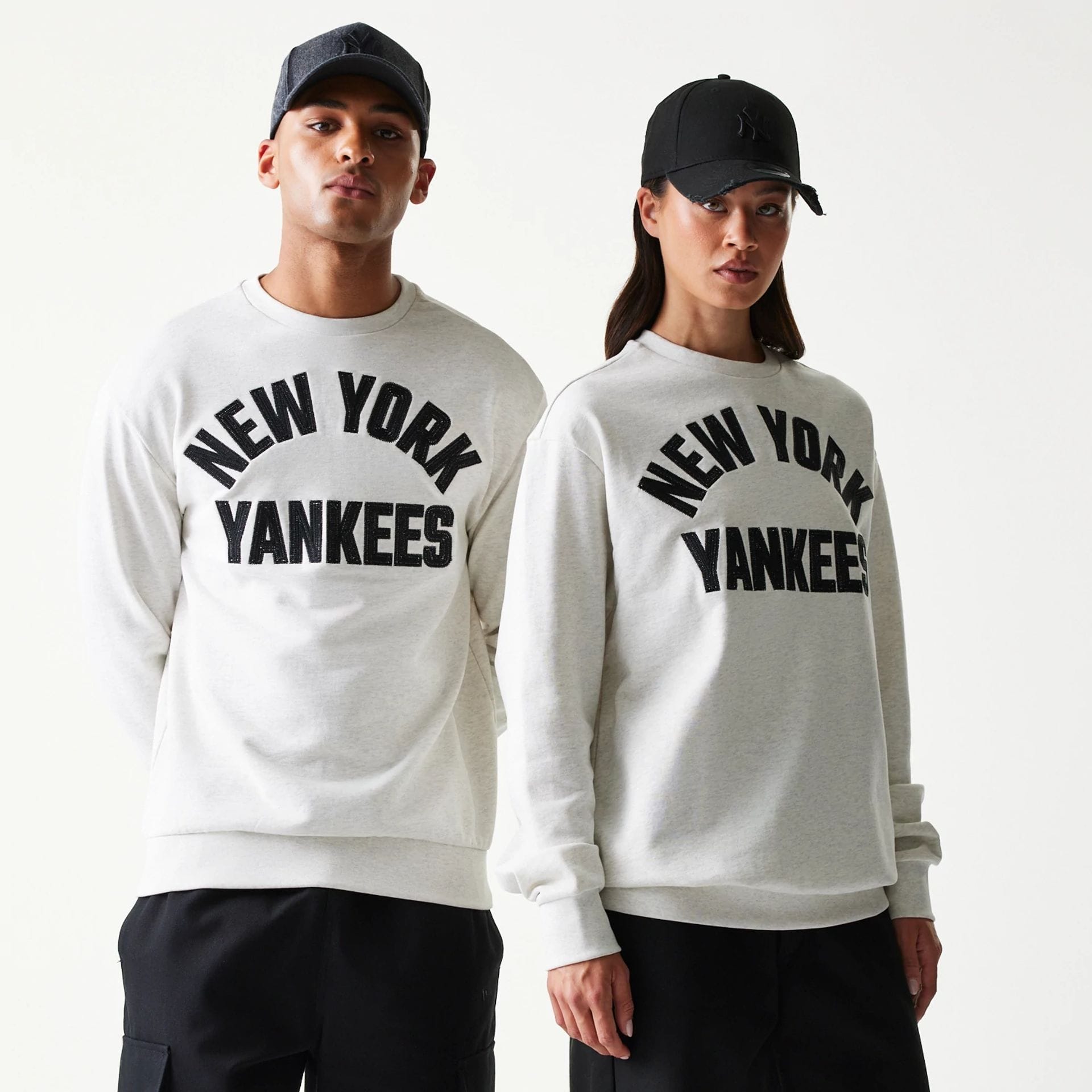 The model is wearing this MLB Graphic New York Yankees Oversized Crew Neck Sweater in pastel grey. 1