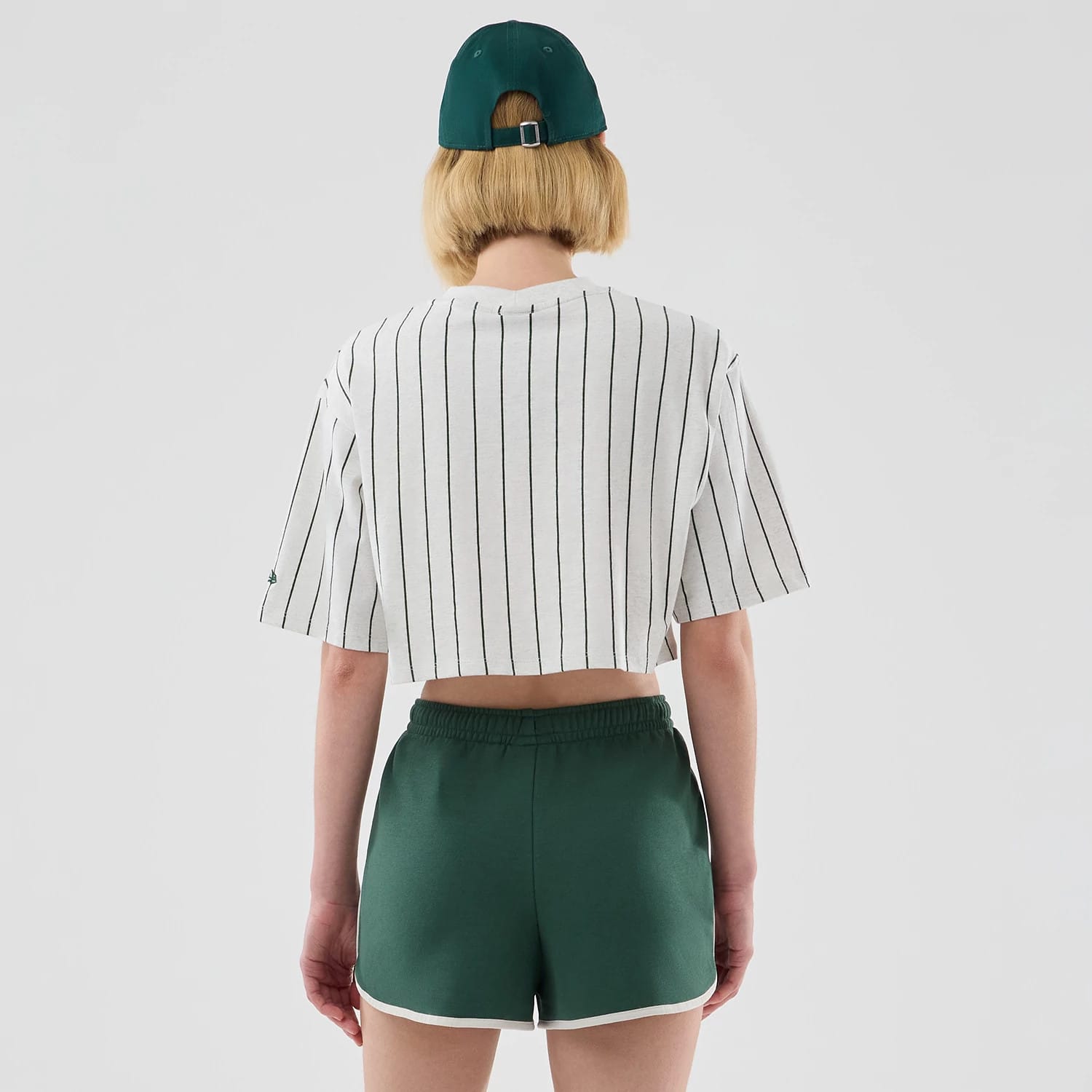The model is wearing this Womens New Era Pinstripe Cropped T-shirt in pastel grey. 2