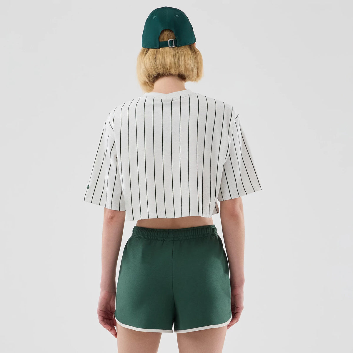 The model is wearing this Womens New Era Pinstripe Cropped T-shirt in pastel grey. 2