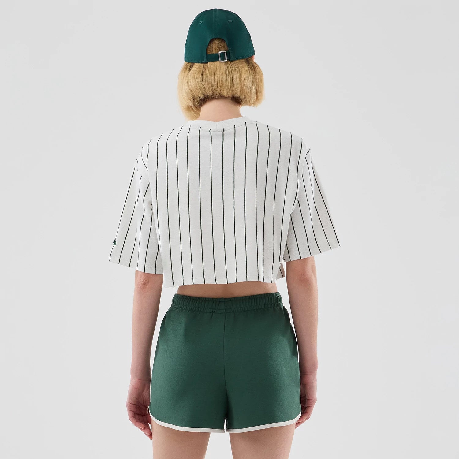 The model is wearing this Womens New Era Pinstripe Cropped T-shirt in pastel grey. 2