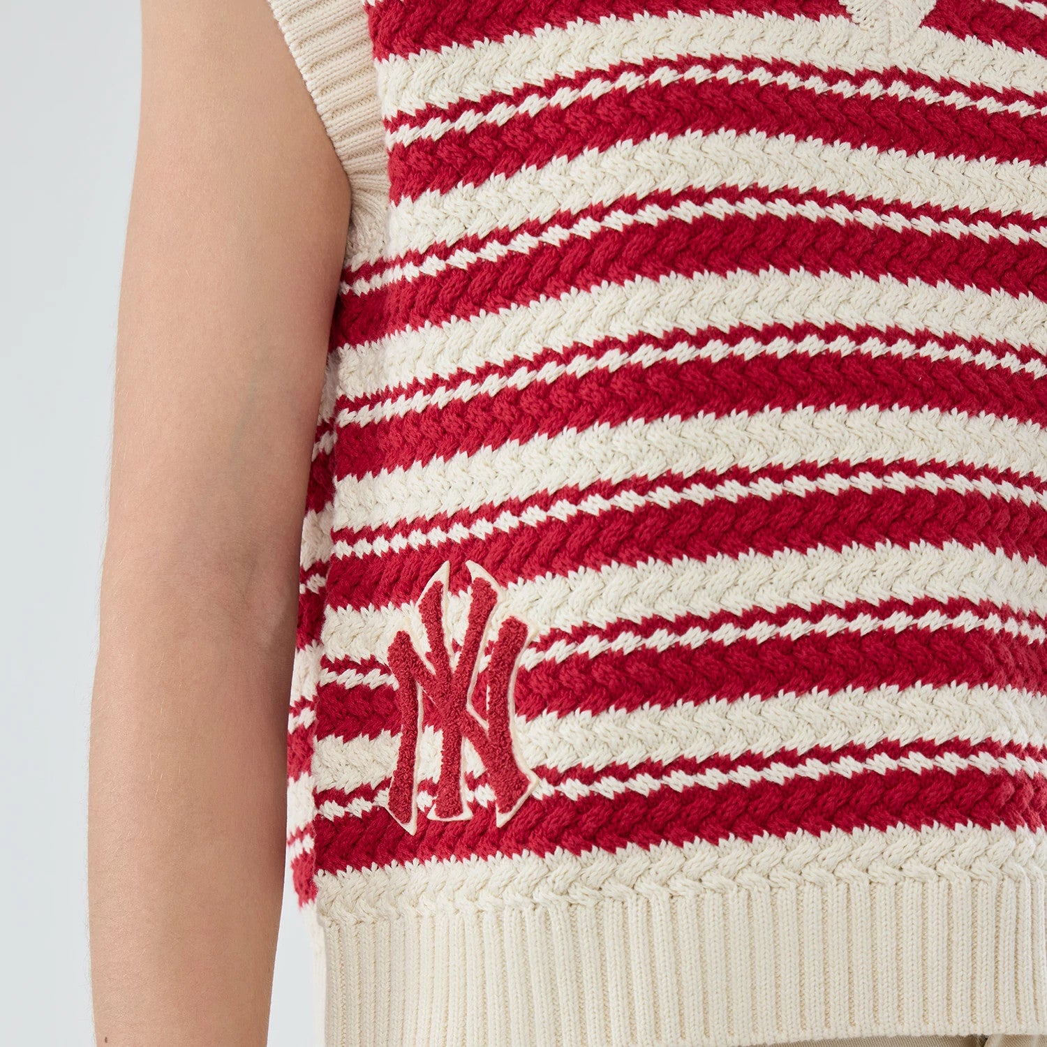 The model is wearing this Womens MLB Knit Stripe New York Yankees Sleeveless V-neck Sweater in dark red. 3