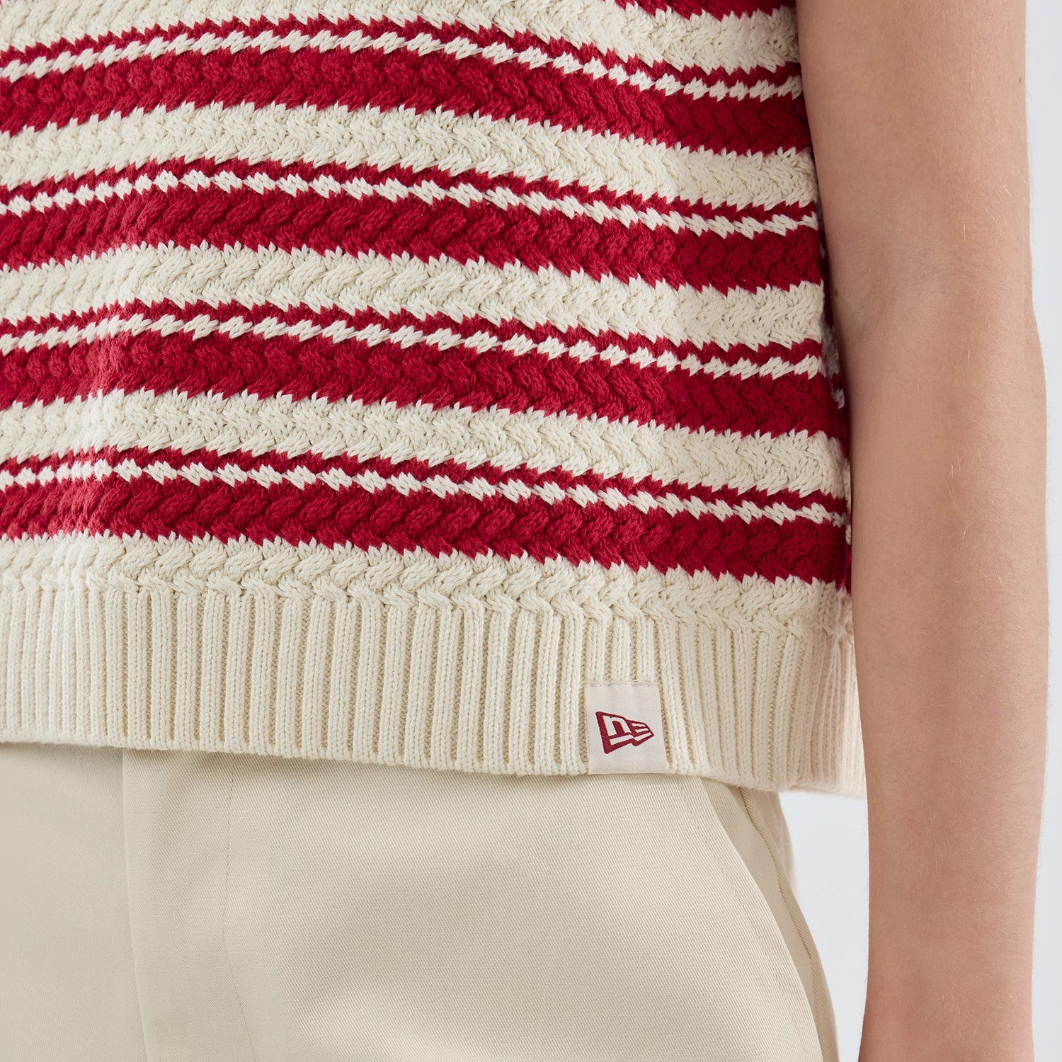 The model is wearing this Womens MLB Knit Stripe New York Yankees Sleeveless V-neck Sweater in dark red. 4