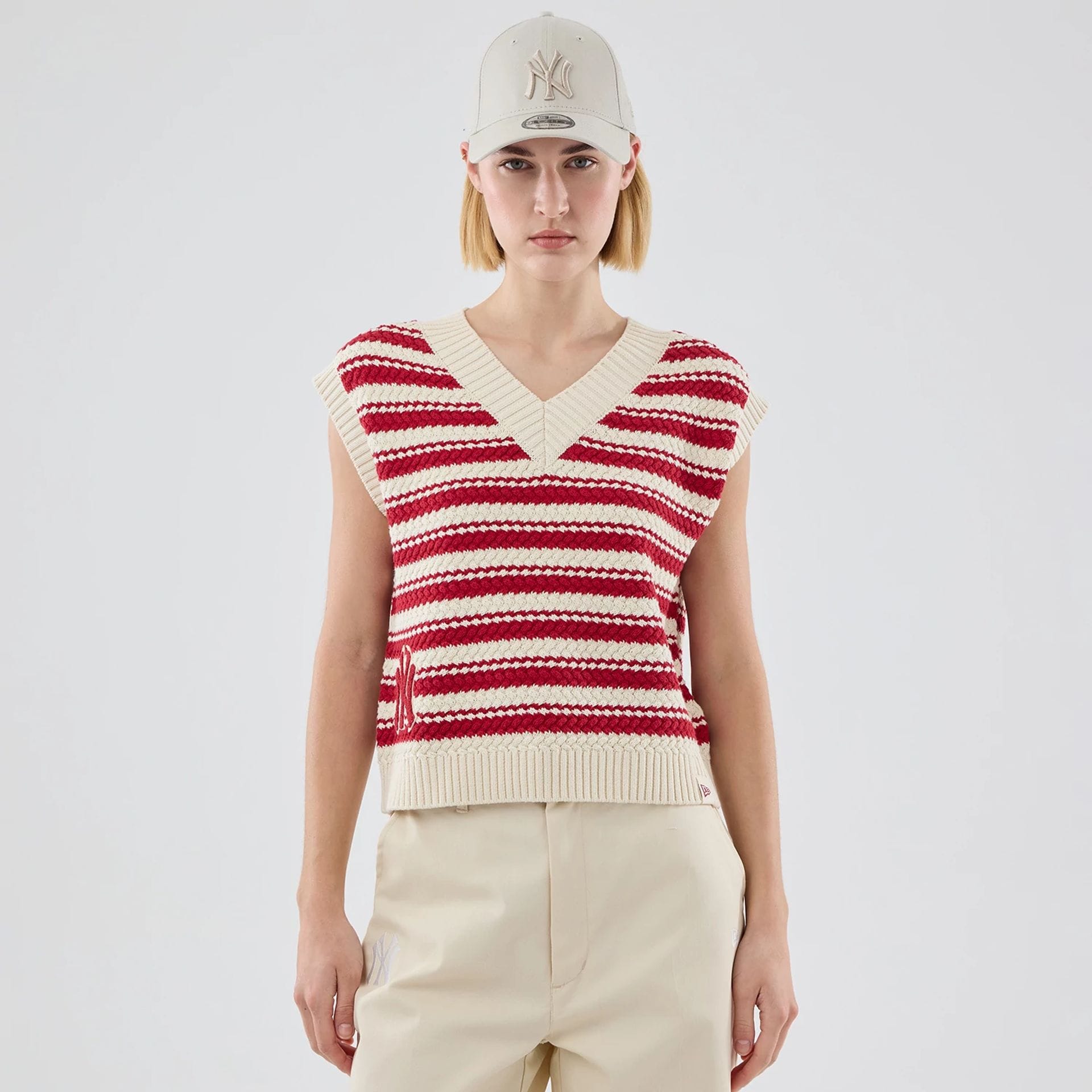 The model is wearing this Womens MLB Knit Stripe New York Yankees Sleeveless V-neck Sweater in dark red. 1
