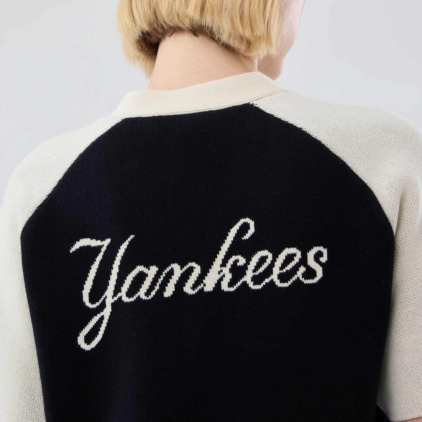 The model is wearing this Womens MLB Knit Stripe New York Yankees Short Sleeve Cardigan in black. 7
