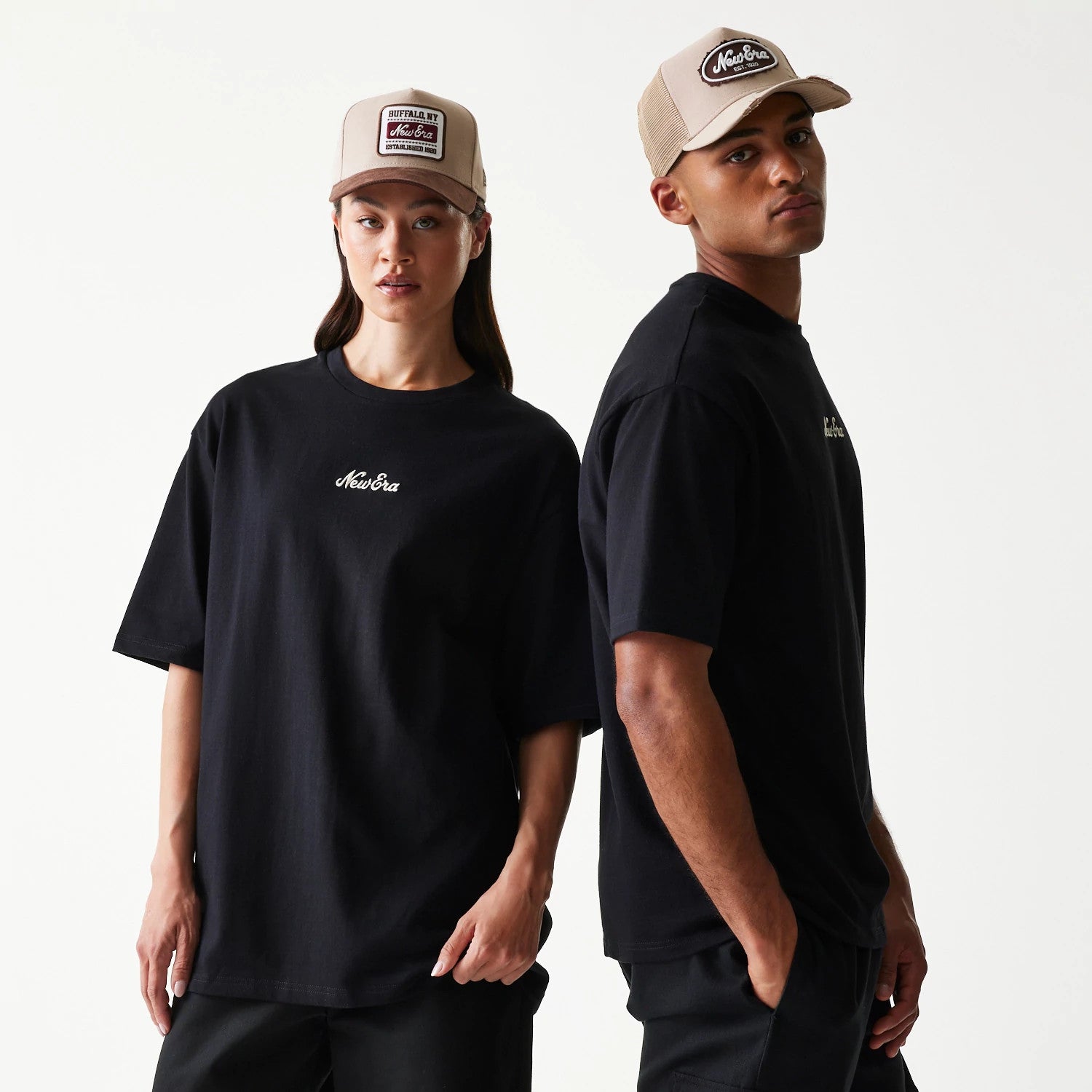The model is wearing this New Era Heritage Script T-Shirt in black. 1