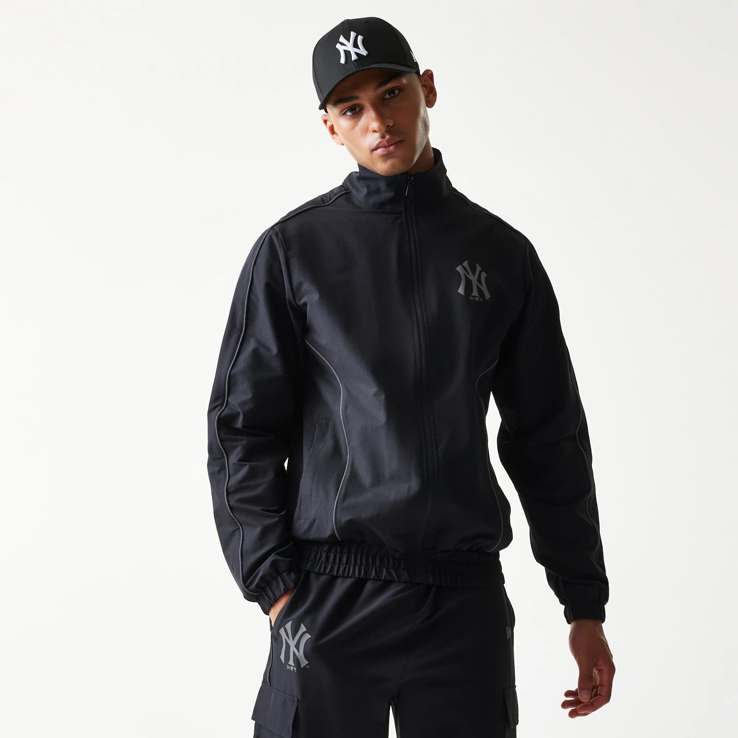 The model is wearing this MLB New York Yankees Track Jacket in black. 3