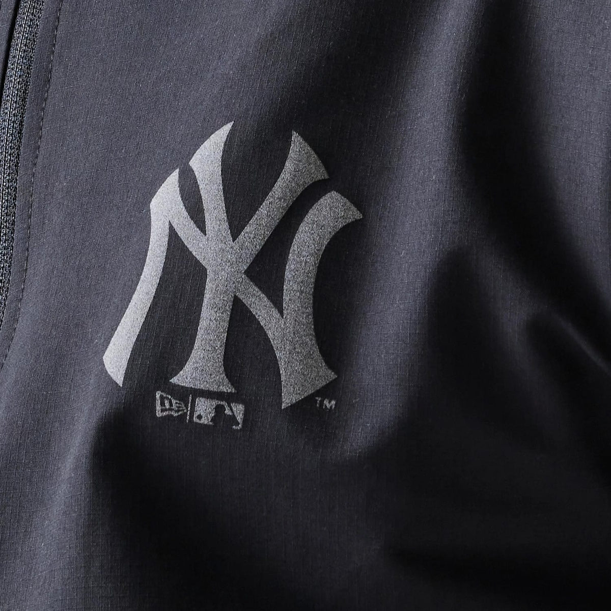 The model is wearing this MLB New York Yankees Track Jacket in black. 8
