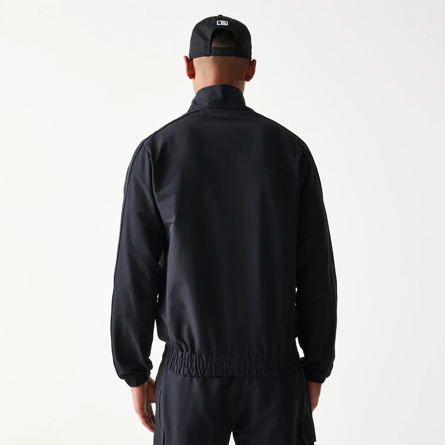 The model is wearing this MLB New York Yankees Track Jacket in black. 2