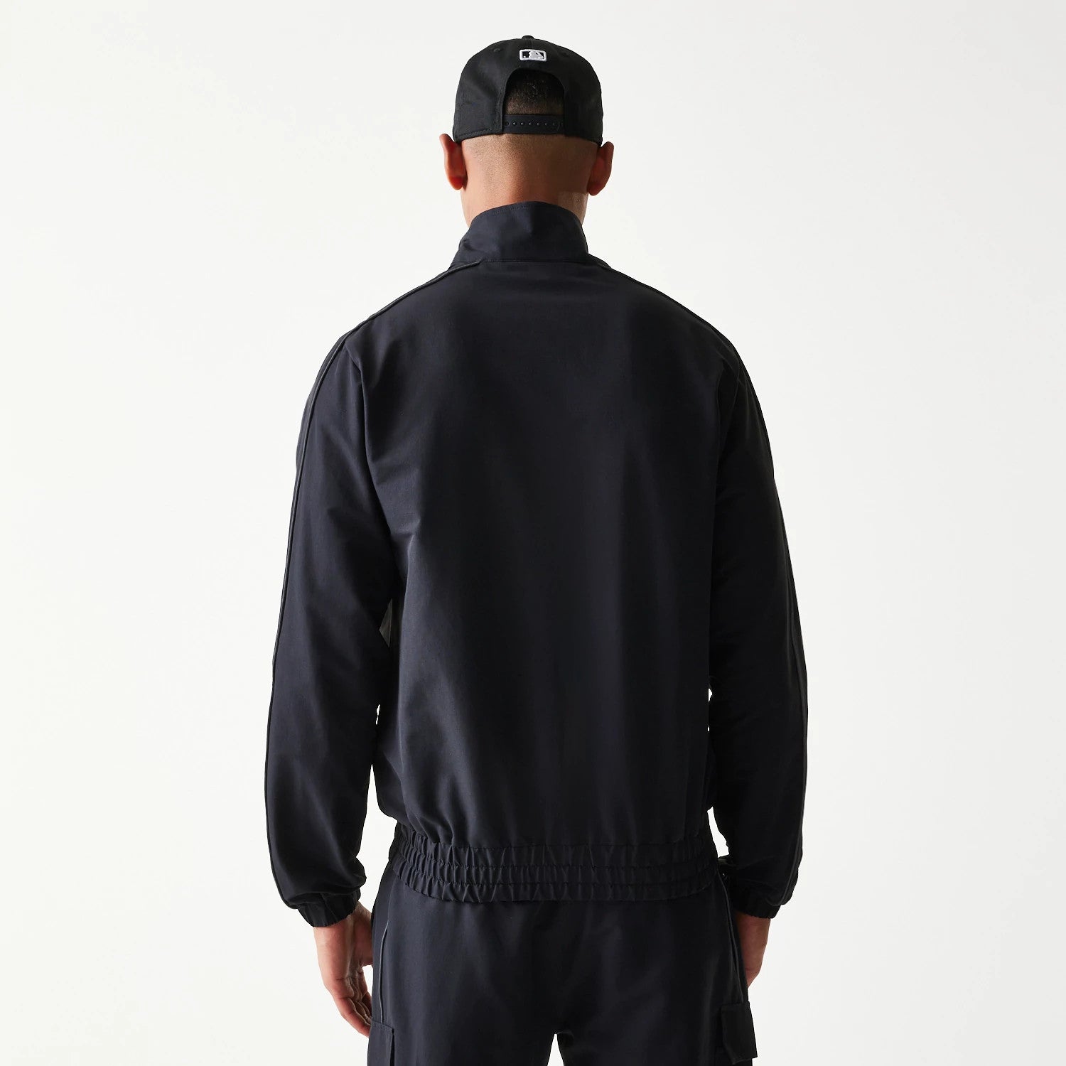 The model is wearing this MLB New York Yankees Track Jacket in black. 2