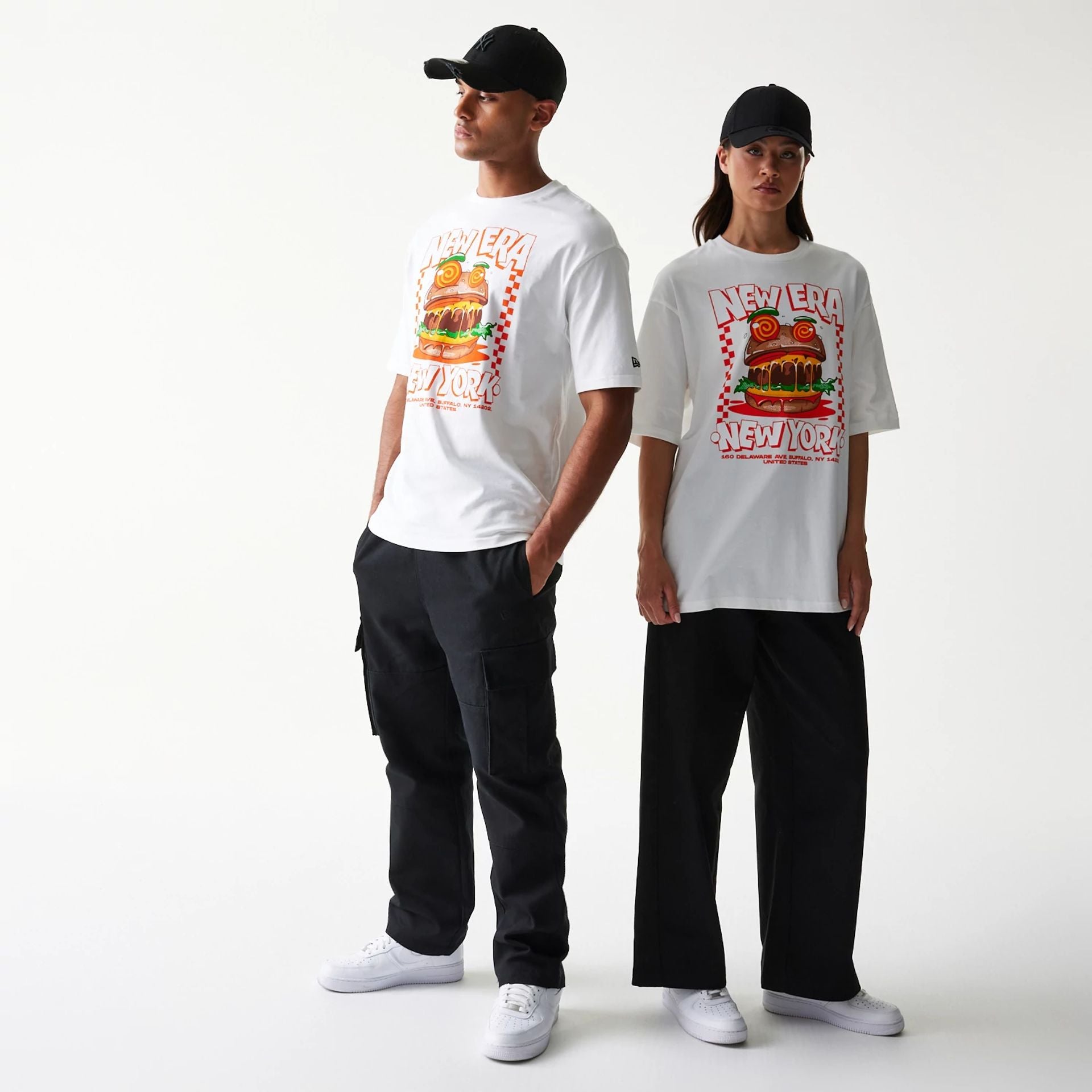 The model is wearing this New Era Burger Food Graphic Oversized T-Shirt in white. 1
