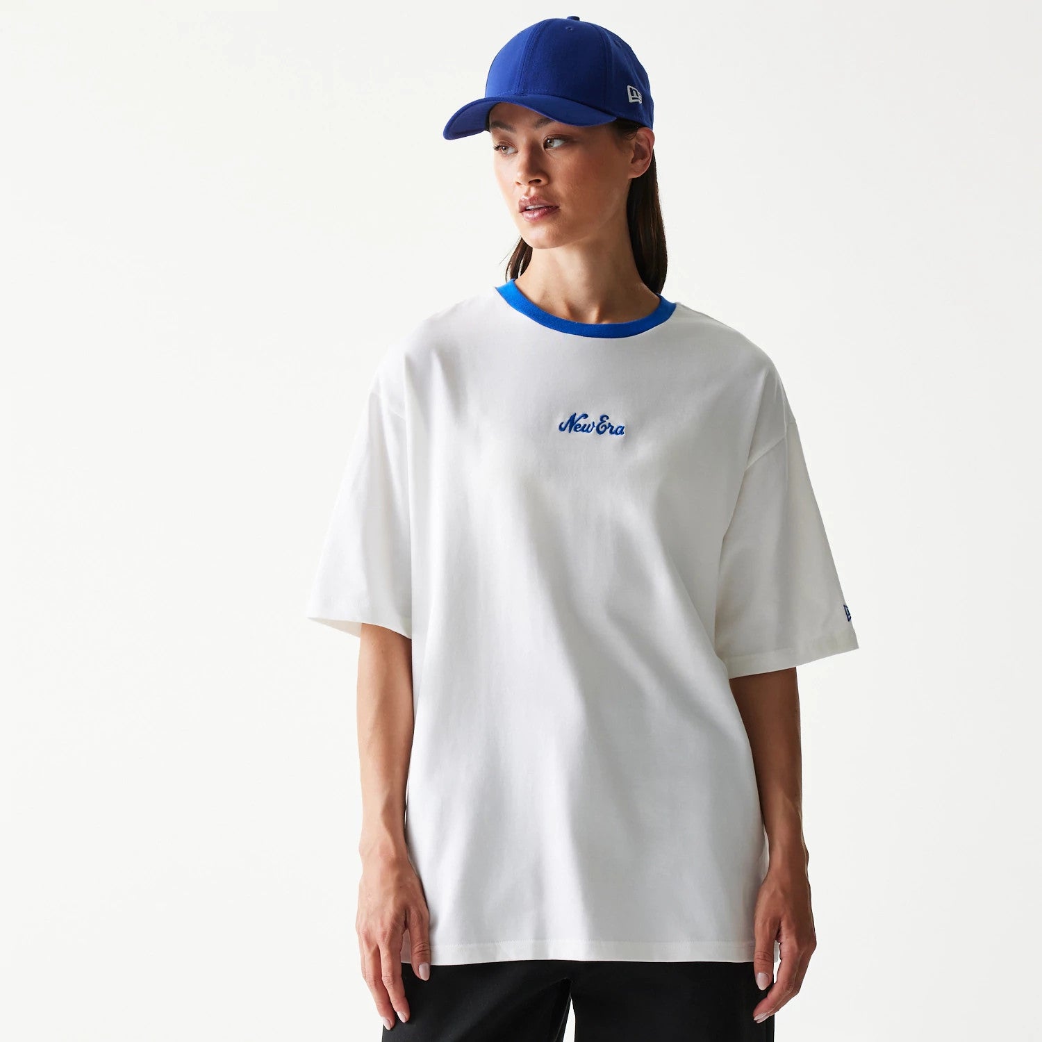 The model is wearing this New Era Script Oversized T-Shirt in white. 4