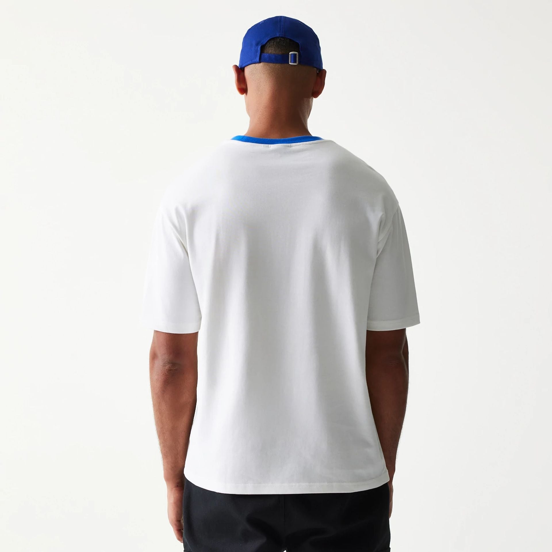 The model is wearing this New Era Script Oversized T-Shirt in white. 2
