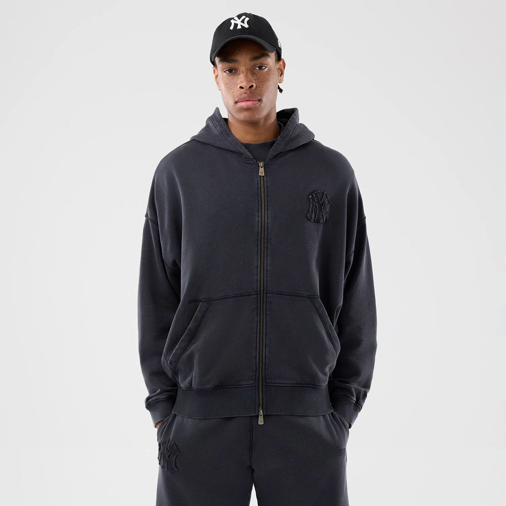 The model is wearing this MLB Washed New York Yankees Full Zip Hoodie in black. 1